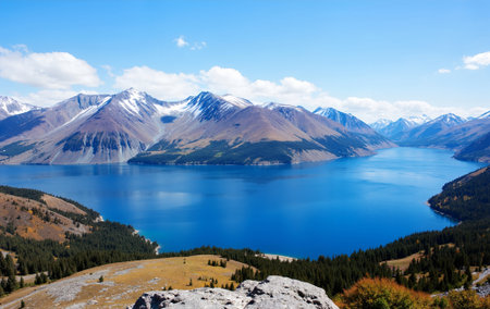Landscape view of a lake in the mountains during a cloudy day.の素材