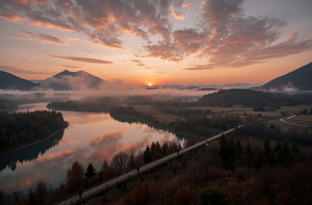 Beautiful autumn landscape with lake and mountains in fog at sunrise.の素材