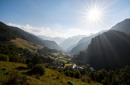 Sunset in the mountains. View of the village in the valley.の素材