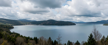 Panoramic view of the lake and mountains on a cloudy dayの素材