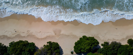 Aerial view of a beach with waves crashing on the sand.の素材