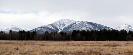 Panoramic view of the snow-capped mountains in early springの素材