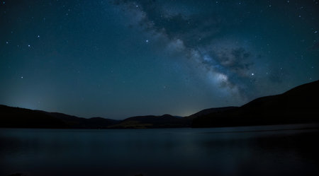 Milky Way over the lake. Long exposure photograph with grain.の素材