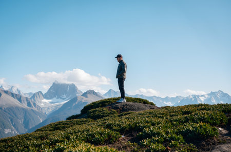 Hiker standing on the top of a mountain with the Matterhorn in the backgroundの素材