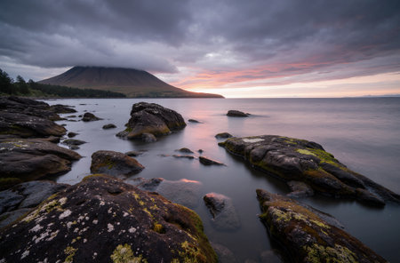 Beautiful sunrise over the sea and mountains in the background. Scotland, UKの素材
