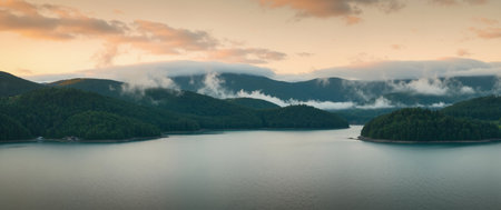 Panoramic view of the lake in the mountains at sunset.の素材