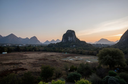 Landscape view of karst mountains at sunset, China.の素材