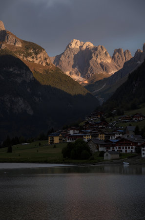 Mountain village in the italian alps at night with lakeの素材