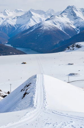 Mountain landscape with snow and ski tracks in Alps, Switzerland.の素材