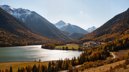 Autumn alpine landscape with lake and snowcapped mountain rangeの素材