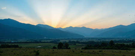 Sunset in the mountains. Panoramic view of the valley.の素材