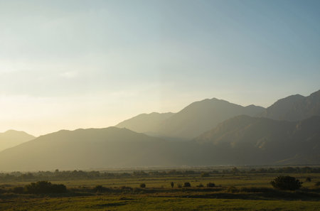 Sunset in the middle of the desert with mountains in the backgroundの素材