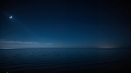 Night sky with stars and moon over the sea. Long exposure.の素材