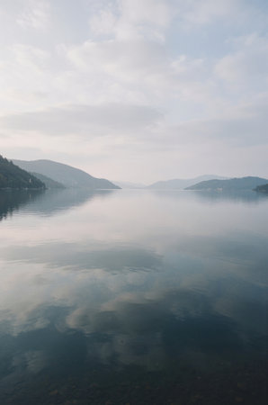 Landscape view of lake and mountains with fog in the morning.の素材