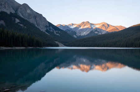 Mountain lake with reflection in the water at sunrise, Alberta, Canadaの素材