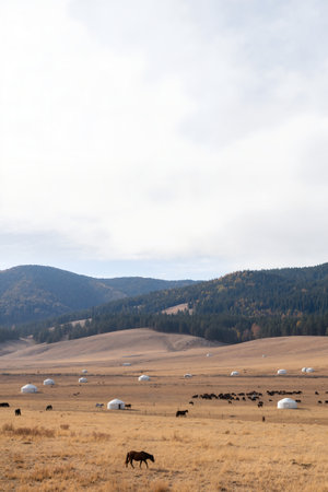 Mongolian steppe landscape with horses and sheep in autumnの素材