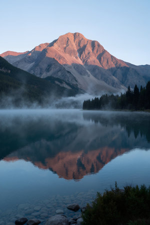 Mountains reflected in the lake at sunrise, Alberta, Canada.の素材