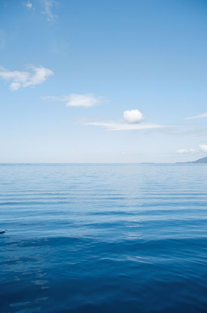 Blue sea and blue sky with white clouds. Seascape.の素材