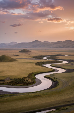 Mongolian steppe landscape with river and mountains at sunsetの素材