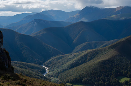 Mountain landscape with a river in the middle of the valley.の素材