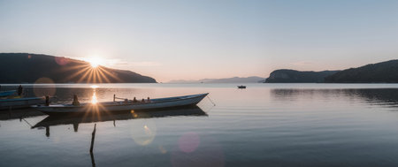 Fishing boats on the lake at sunset. Panoramic viewの素材