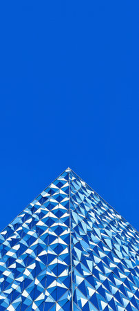 Detail of the facade of a modern office building with blue skyの素材