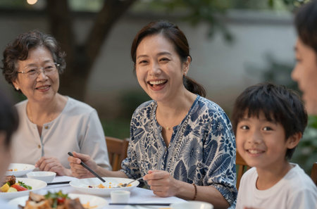 Happy Asian family having dinner together in the garden at home. Family and lifestyle concept.の素材