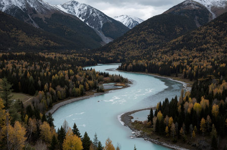 Autumn alpine landscape with river and snow-capped mountainsの素材