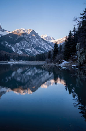 Reflection of the mountains in the lake at sunrise in winter.の素材