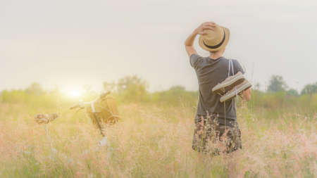 Girl in golden meadow, Canvas shoes, bikes in her vacation.の写真素材