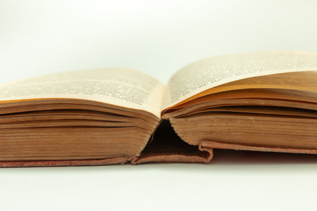unrolled old book on white backgroundの写真素材