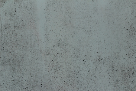 background grey concrete wall with black spots of paintの写真素材