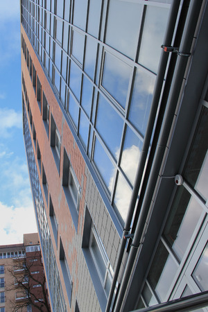 it is a lot of windows with a white frame on the brick buildingの写真素材