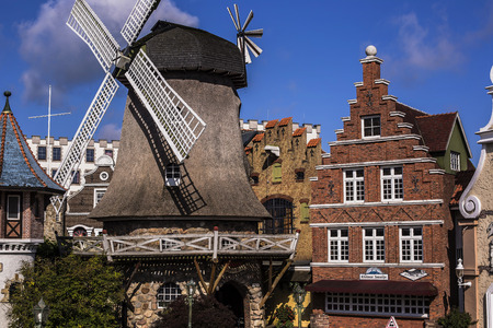 colorful facade of brick buildings with mill ,Park near Hamburgのeditorial素材