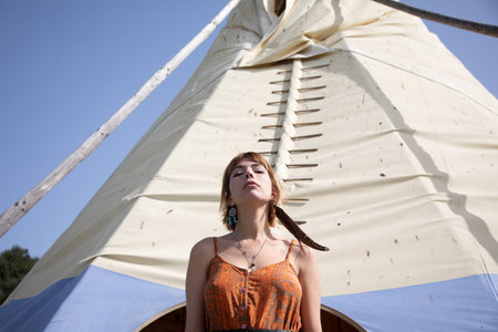 Young blonde boho female beauty on a nature backgroundの写真素材