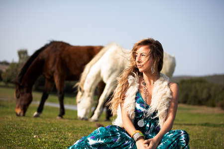 Young blonde boho female beauty on a nature backgroundの写真素材