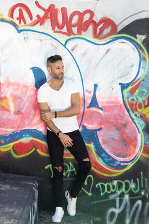 A young handsome bearded man posing in an urban backgroundの写真素材