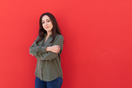 Young Brunette elegant woman wearing a casual green shirtの写真素材