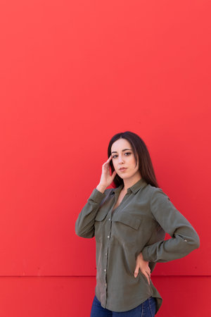 Young Brunette elegant woman wearing a casual green shirt