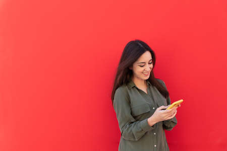 Young Brunette elegant woman wearing a casual green shirtの写真素材