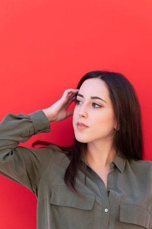 Young Brunette elegant woman wearing a casual green shirt