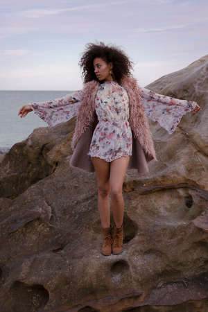 A young beautiful woman in a beach in winterの写真素材