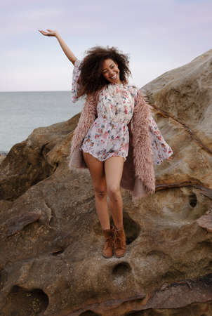 A young beautiful woman in a beach in winterの写真素材