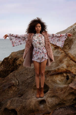 A young beautiful woman in a beach in winterの写真素材