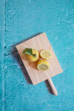 Still Life yellow and lemons in a blue stone backgroundの写真素材