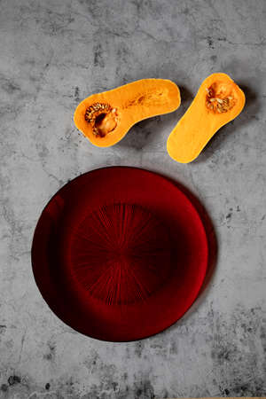 minimalistic still life raw pumpkin in a stone backgroundの写真素材