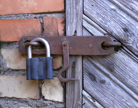 lock on the door of an old farmhouse . true village style .の写真素材