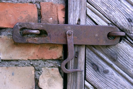 lock on the door of an old farmhouse . true village style .の写真素材