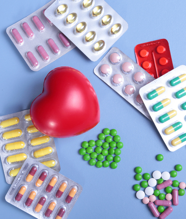 Packaging of tablets and pills on the table. Red heartの写真素材