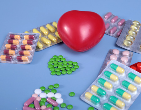 Packaging of tablets and pills on the table. Red heartの写真素材